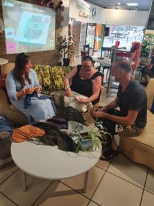 Three people at an upcycling workshop